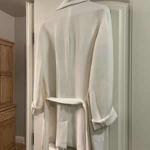 Unstructured blazer with rolled sleeves and tie belt.